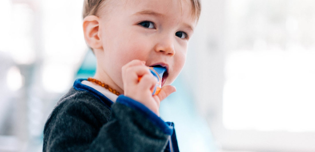 Major Martino wears a grey mohair suit and brushes his few teeth with a baby tooth brush in the family room of his Connecticut home