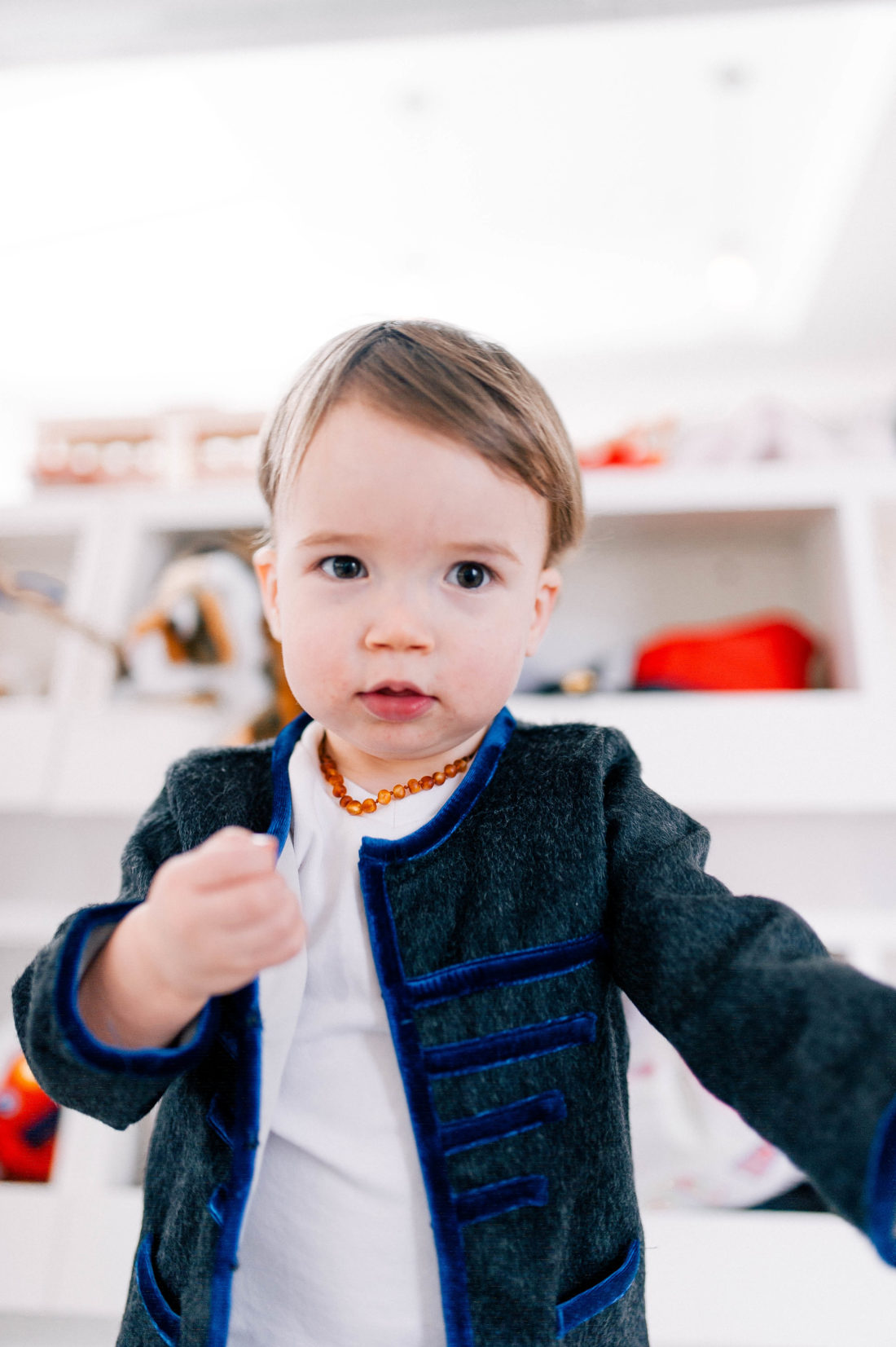 Major Martin wears an amber teething necklace and plays in the family room of his Connecticut home
