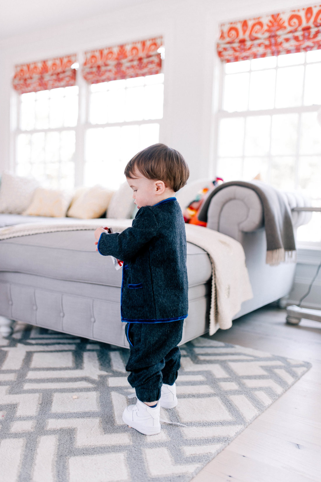 Major Martino stands in the family room of his Connecticut home wearing a dark grey mohair suit