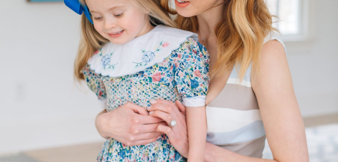 Eva Amurri Martino holds three year old daughter Marlowe Martino on her lap wearing a floral dress for Easter