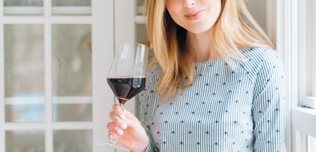 Eva Amurri Martino sips on a glass of red wine in a blue top at her Connecticut home
