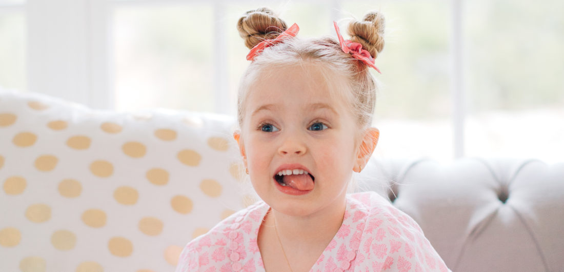 Marlowe Martino shows off her twisted double bun hairstyle on the couch in her Connecticut home.