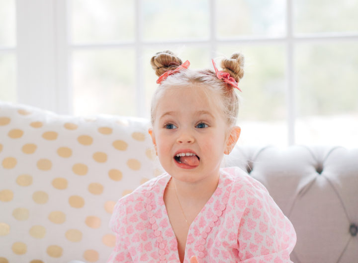Marlowe Martino shows off her twisted double bun hairstyle on the couch in her Connecticut home.