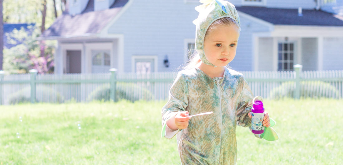 Eva Amurri Martino's daughter Marlowe wars a dinosaur costume and carries bubbles