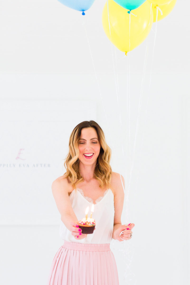 Eva Amurri Martino holds a cupcake with a candle to commemorate the 3rd birthday of her blog REZTT