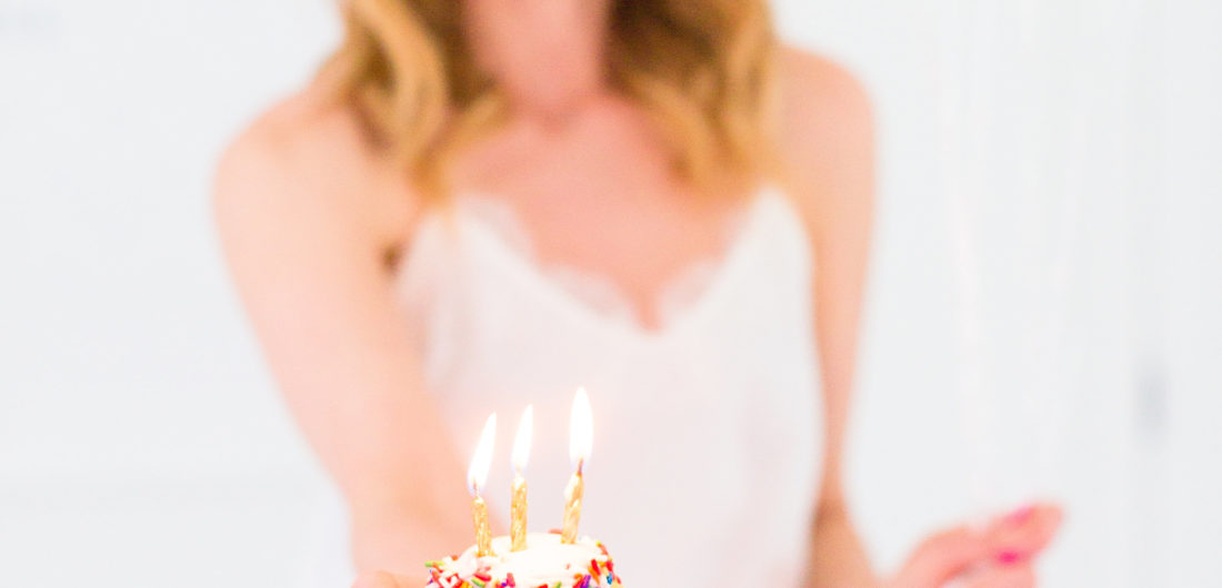 Eva Amurri Martino holds a cupcake with a candle to commemorate the 3rd birthday of her blog REZTT