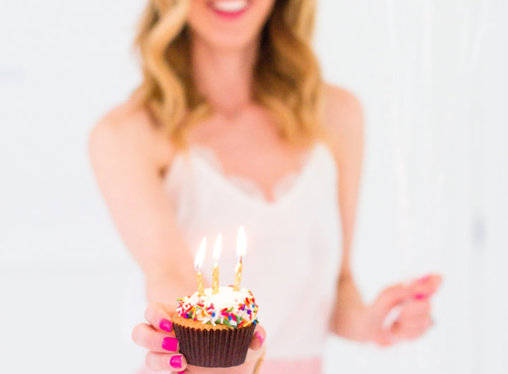 Eva Amurri Martino holds a cupcake with a candle to commemorate the 3rd birthday of her blog REZTT