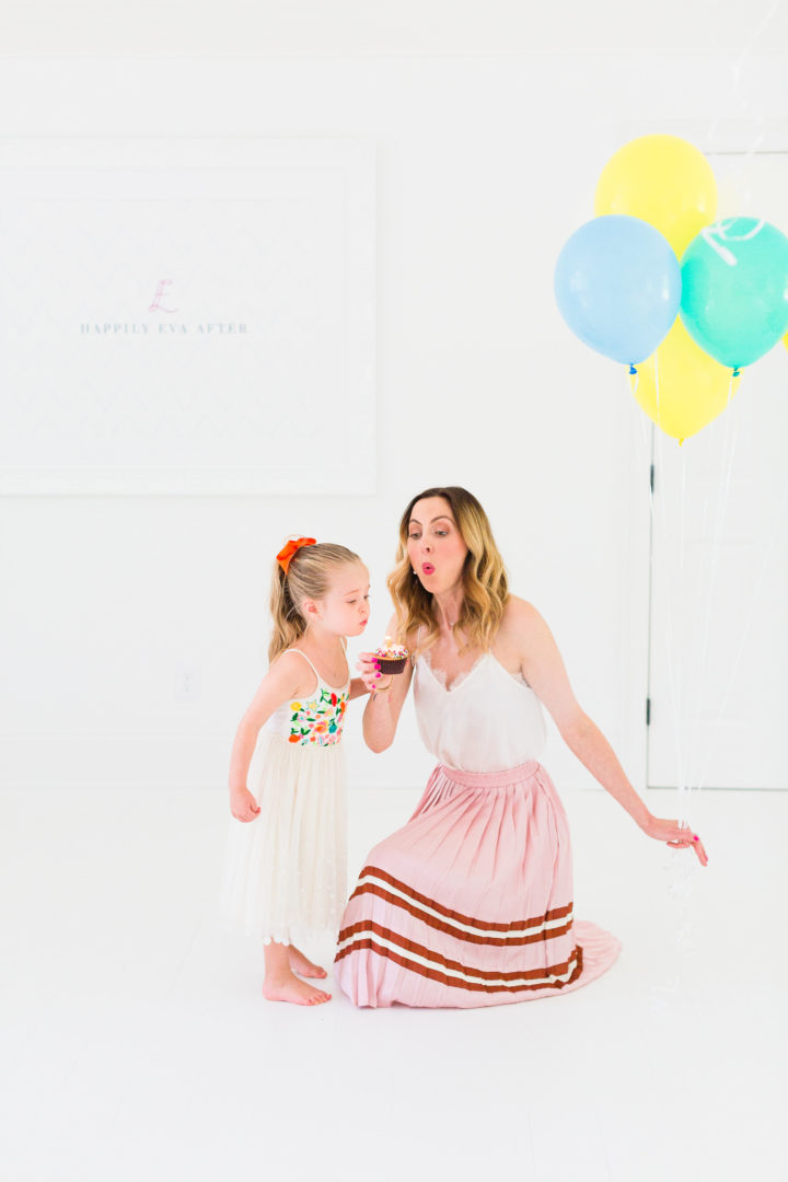 Eva Amurri Martino blows out a candle on a cupcake with her daughter Marlowe to celebrate her blog REZTT's 3rd birthday