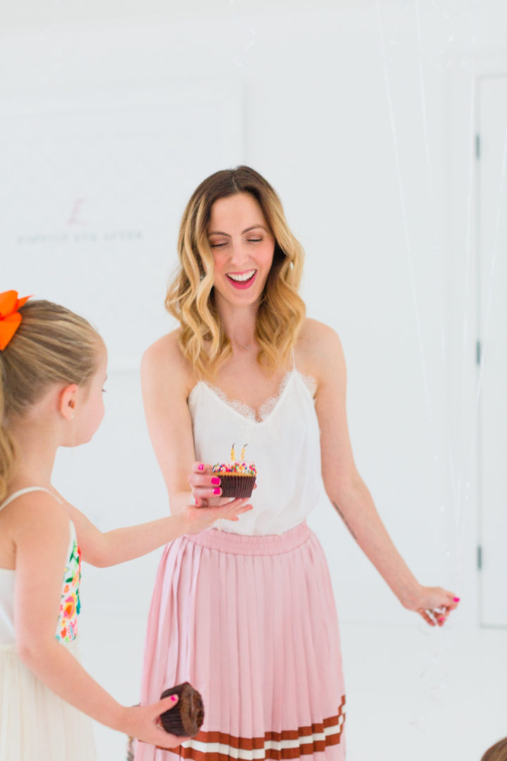 Eva Amurri Martino blows out a candle on a cupcake with her daughter Marlowe to celebrate her blog REZTT's 3rd birthday