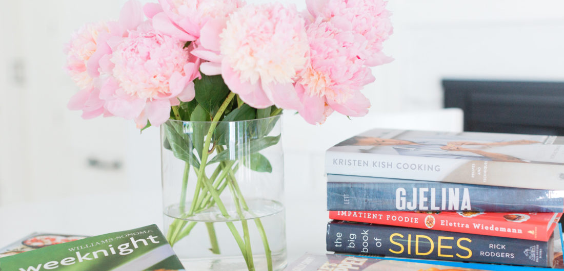 Eva Amurri Martino shares her favorite cookbooks next to a beautiful vase of peonies