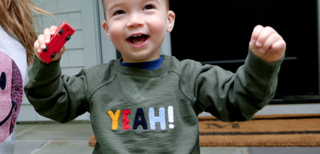 Eva Amurri Martino's son Major throws his hands in the air wearing a 'yeah!' sweatshirt