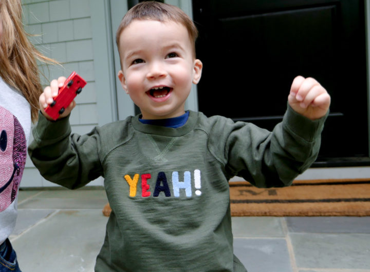 Eva Amurri Martino's son Major throws his hands in the air wearing a 'yeah!' sweatshirt