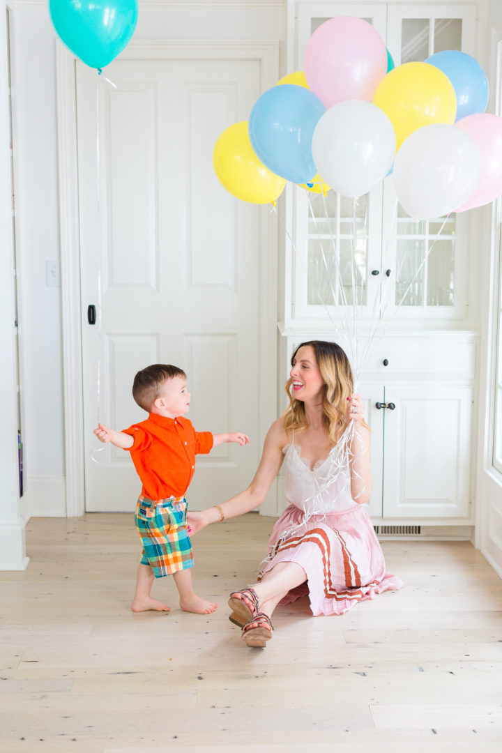 Eva Amurri Martino plays with her son Major while holding a handful of colorful balloons