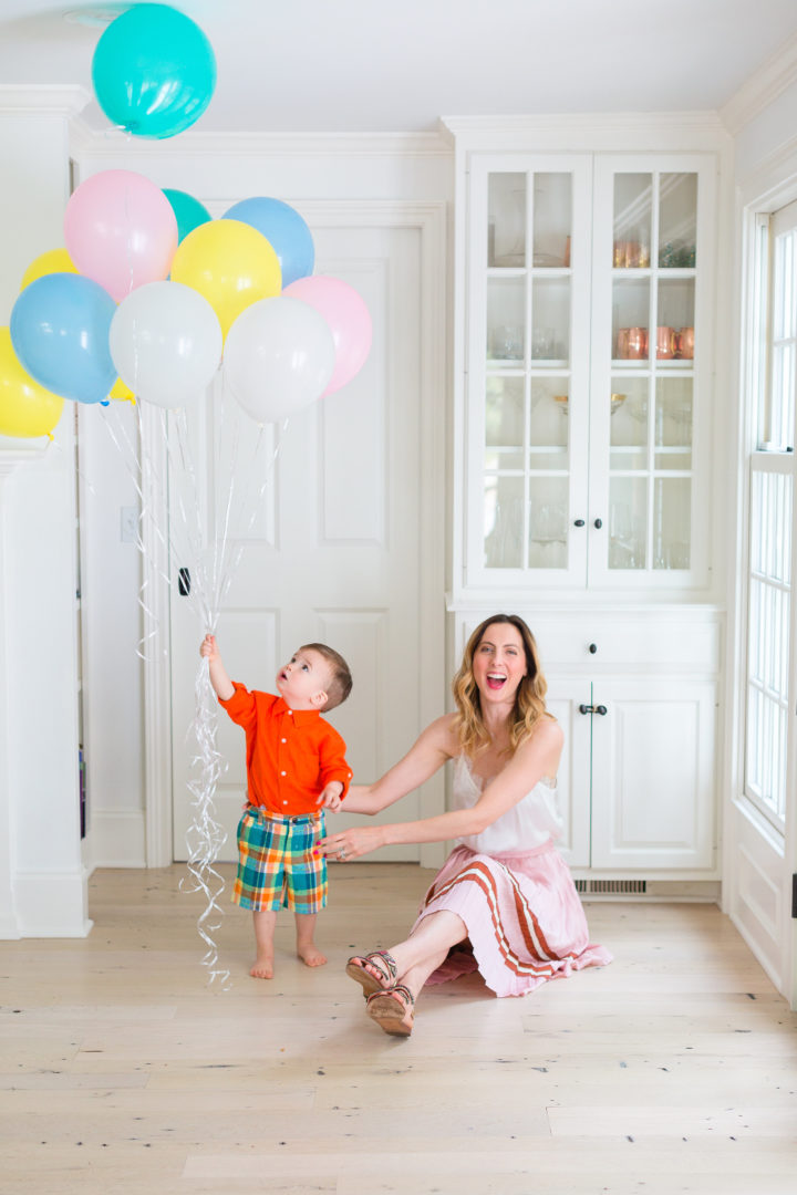 Eva Amurri Martino plays with her son Major while holding a handful of colorful balloons