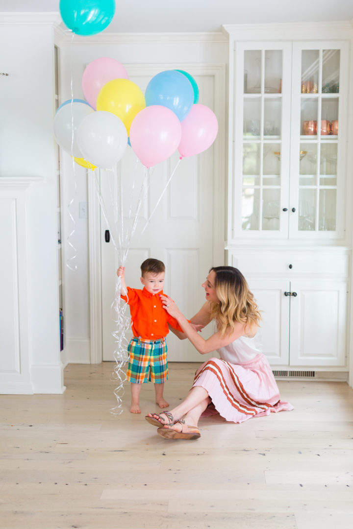 Eva Amurri Martino plays with her son Major while holding a handful of colorful balloons