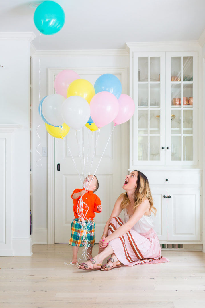 Eva Amurri Martino plays with her son Major while holding a handful of colorful balloons