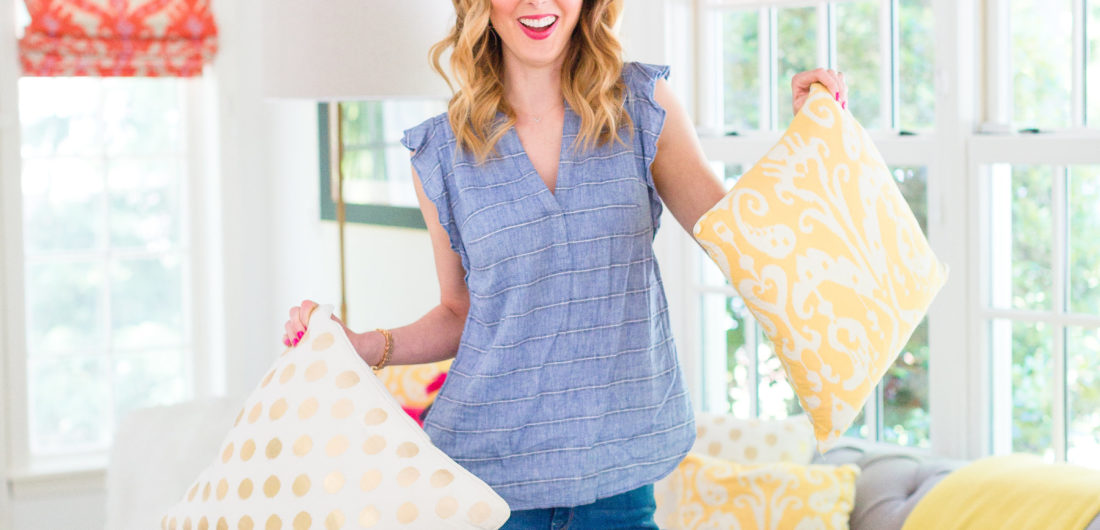 Eva Amurri Martino holds a colorful selection of pillows on her couch at her home in Connecticut