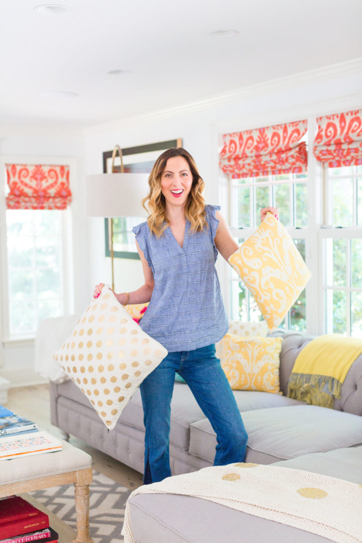 Eva Amurri Martino holds a colorful selection of pillows on her couch at her home in Connecticut