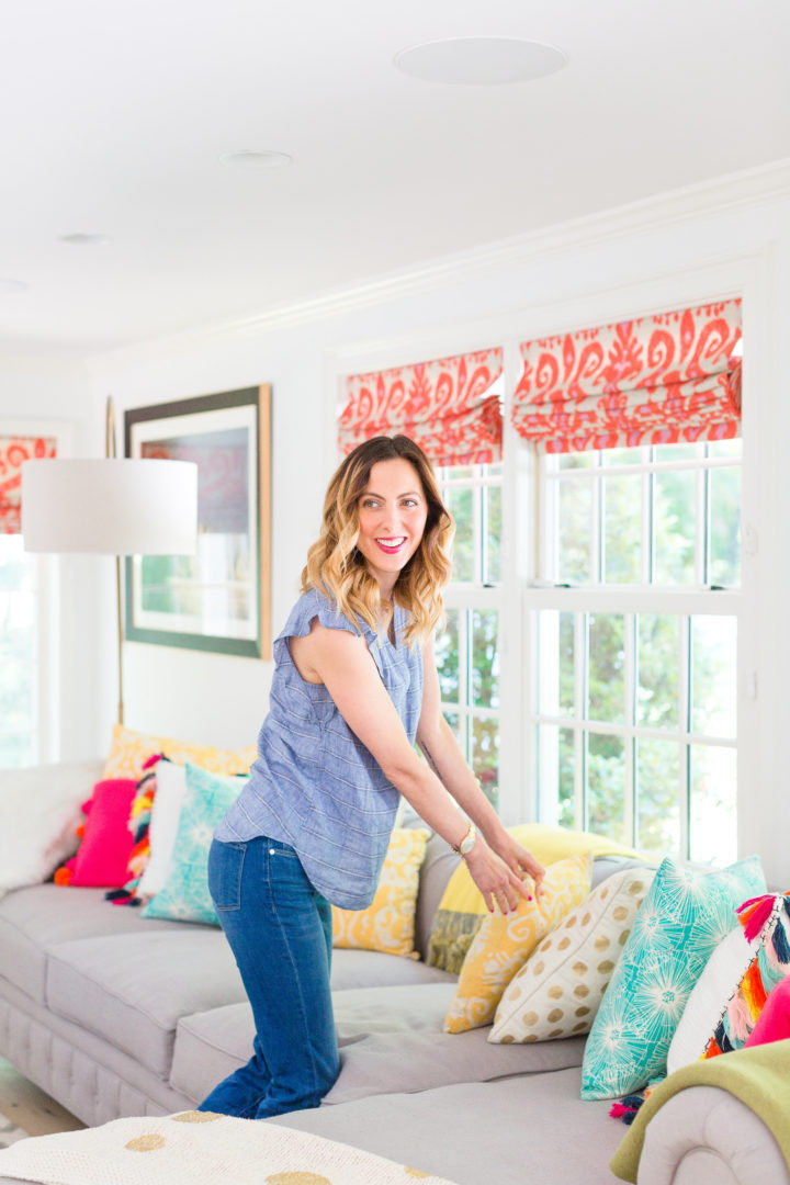 Eva Amurri Martino fluffs a colorful selection of pillows on her couch at her home in Connecticut