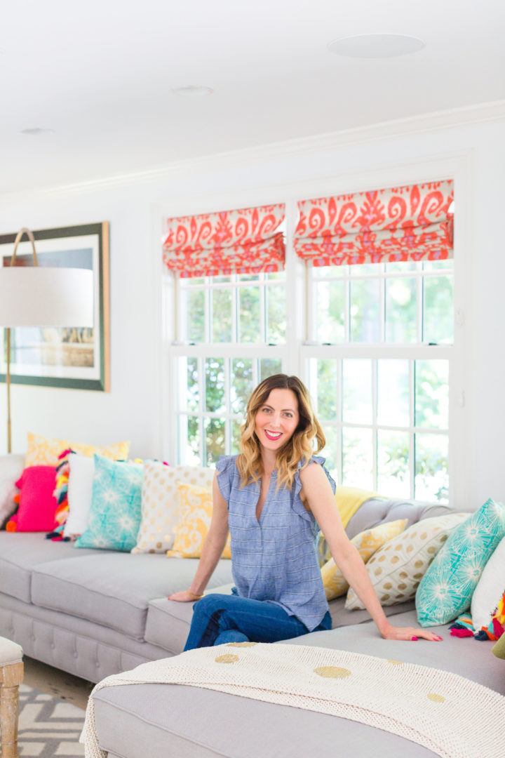 Eva Amurri Martino sits amongst a colorful selection of pillows on her couch at her home in Connecticut