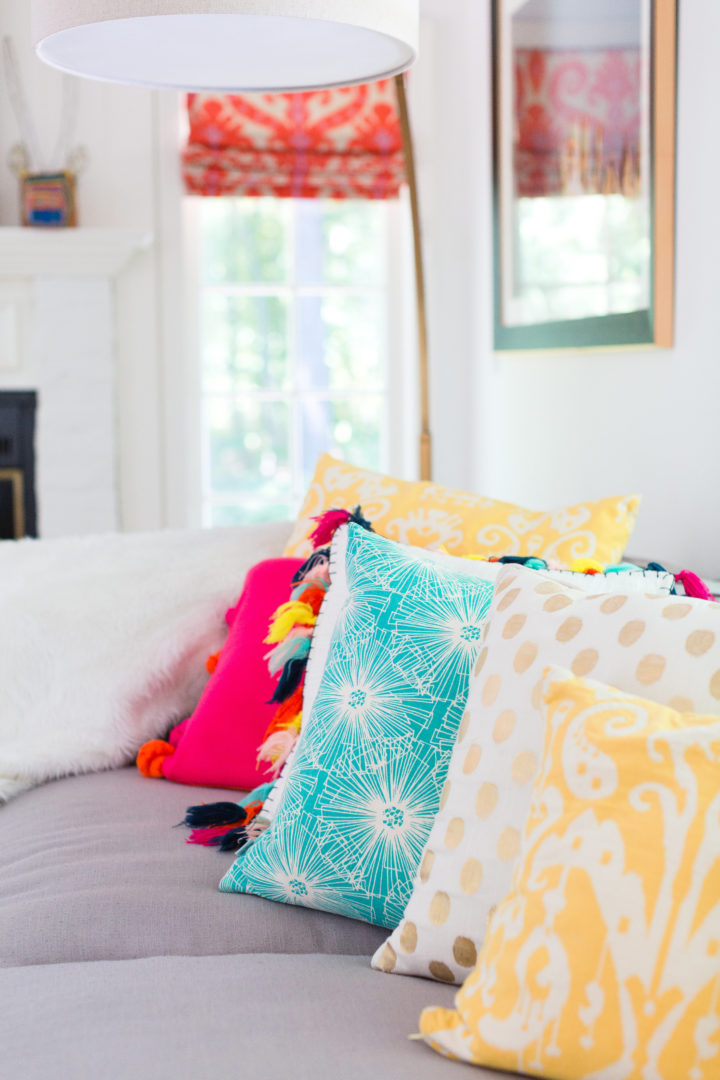 Eva Amurri Martino arranges a colorful selection of pillows on her couch at her home in Connecticut