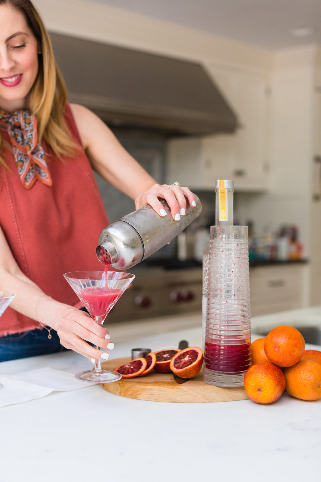 Eva Amurri Martino strains her blood orange and ginger martinis in to awaiting martini glasses