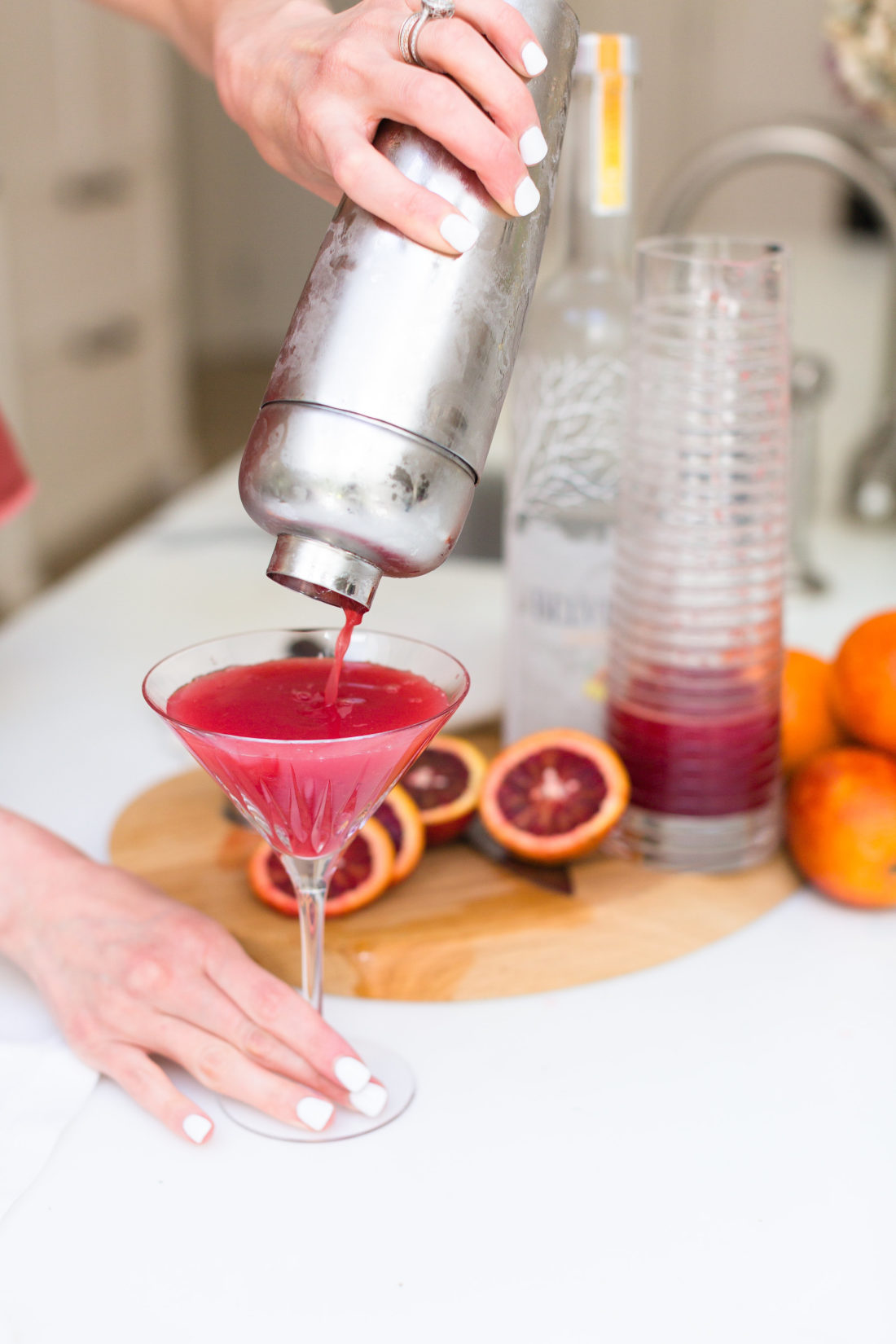 Eva Amurri Martino strains her blood orange and ginger martinis in to awaiting martini glasses