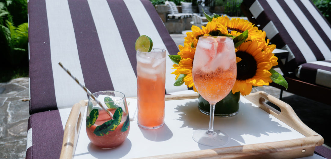 Eva Amurri Martino serves three different pink tinted cocktails to her guests poolside at her home in Connecticut
