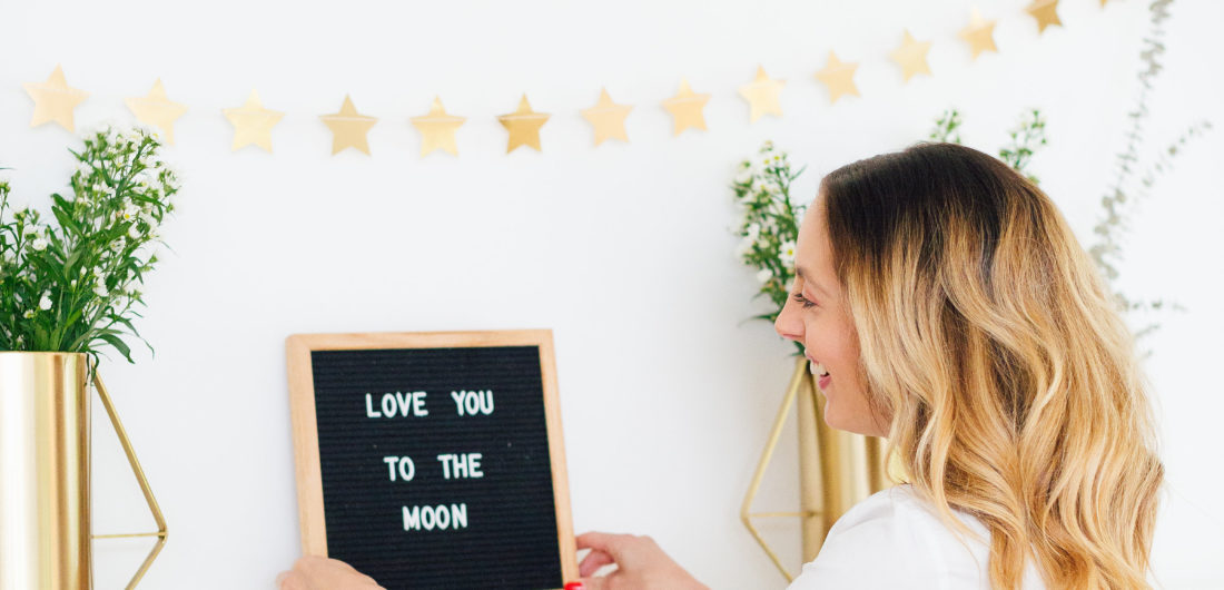 Eva Amurri Martino displays a 'Love You To The Moon' sign at her Celestial Baby Sprinkling Party