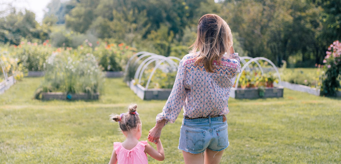 Eva Amurri Martino and Marlowe Martino walk hand in hand through the field of a local connecticut farm