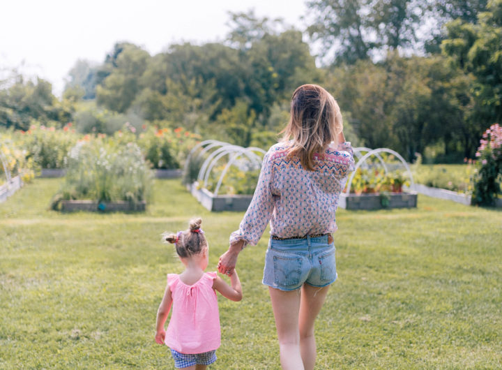 Eva Amurri Martino and Marlowe Martino walk hand in hand through the field of a local connecticut farm