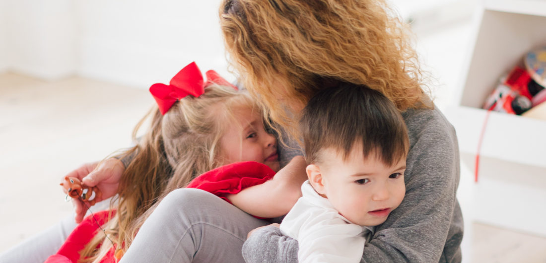 Marlowe and Major Martino snuggle their nanny in the family room of their connecticut home