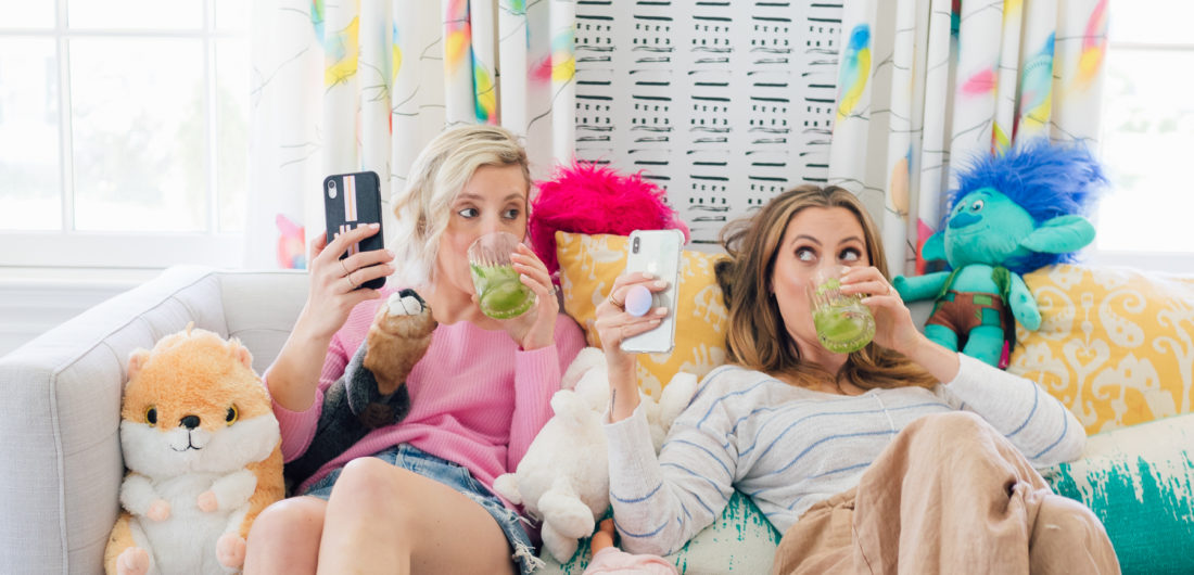 Eva Amurri Martino of REZTT and Julia Dzafic of Lemon Stripes sit on a couch in the Martino house drinking Margaritas and reminiscing on their parenting style