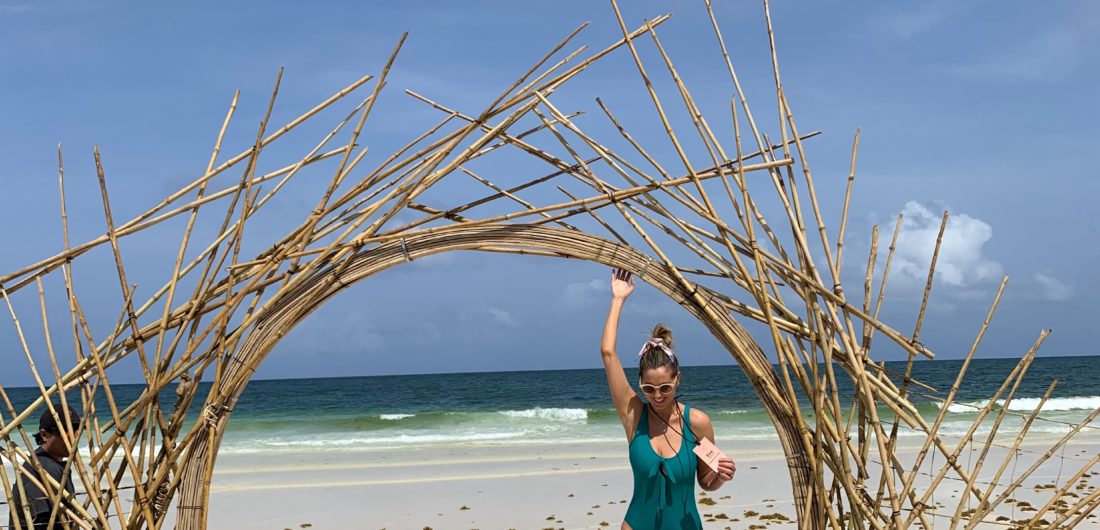 Eva Amurri Martino of REZTT frolicking on a beach at Summit Tulum