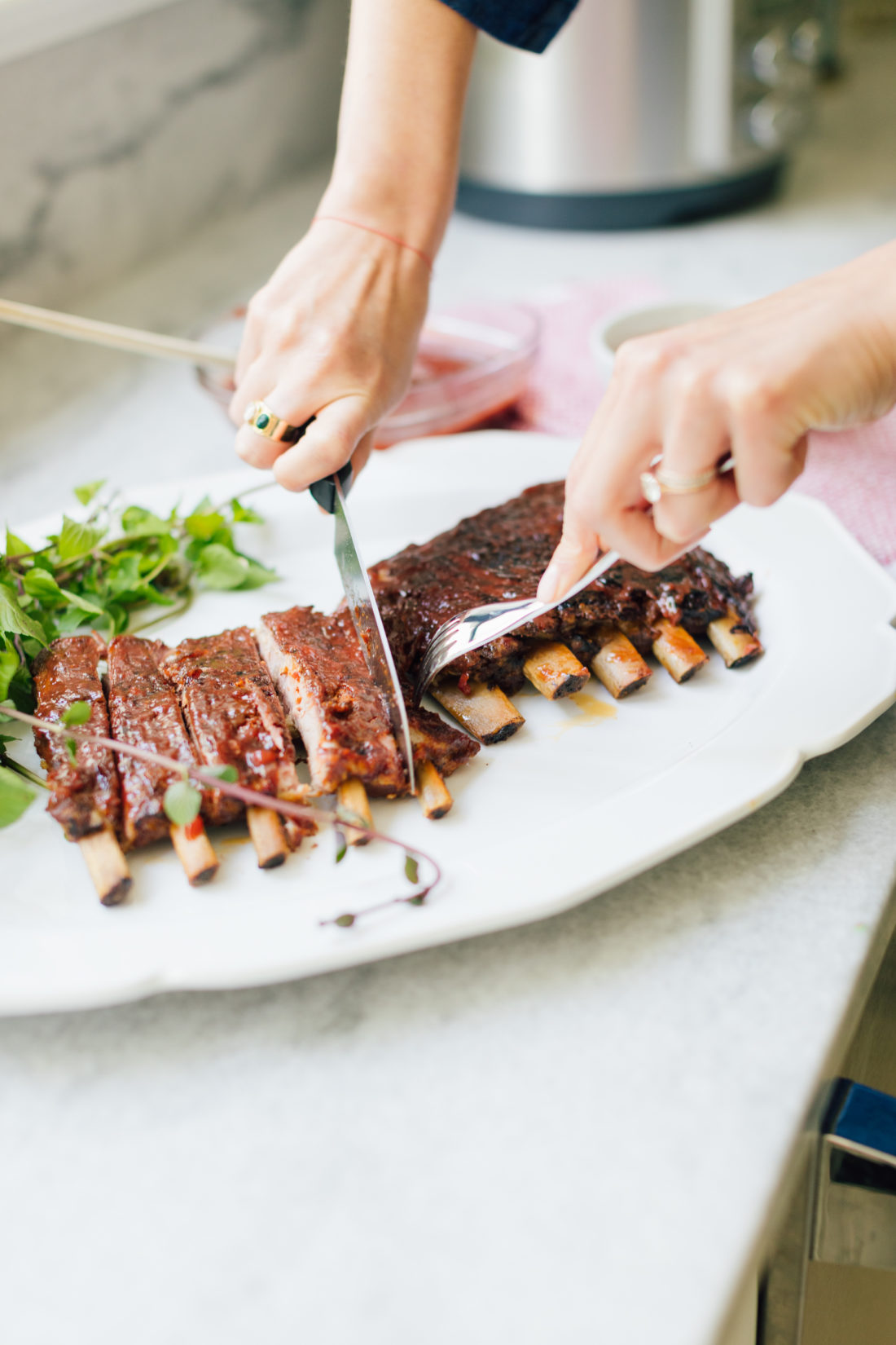 Eva Amurri Martino cuts her rack of ribs on a serving dish