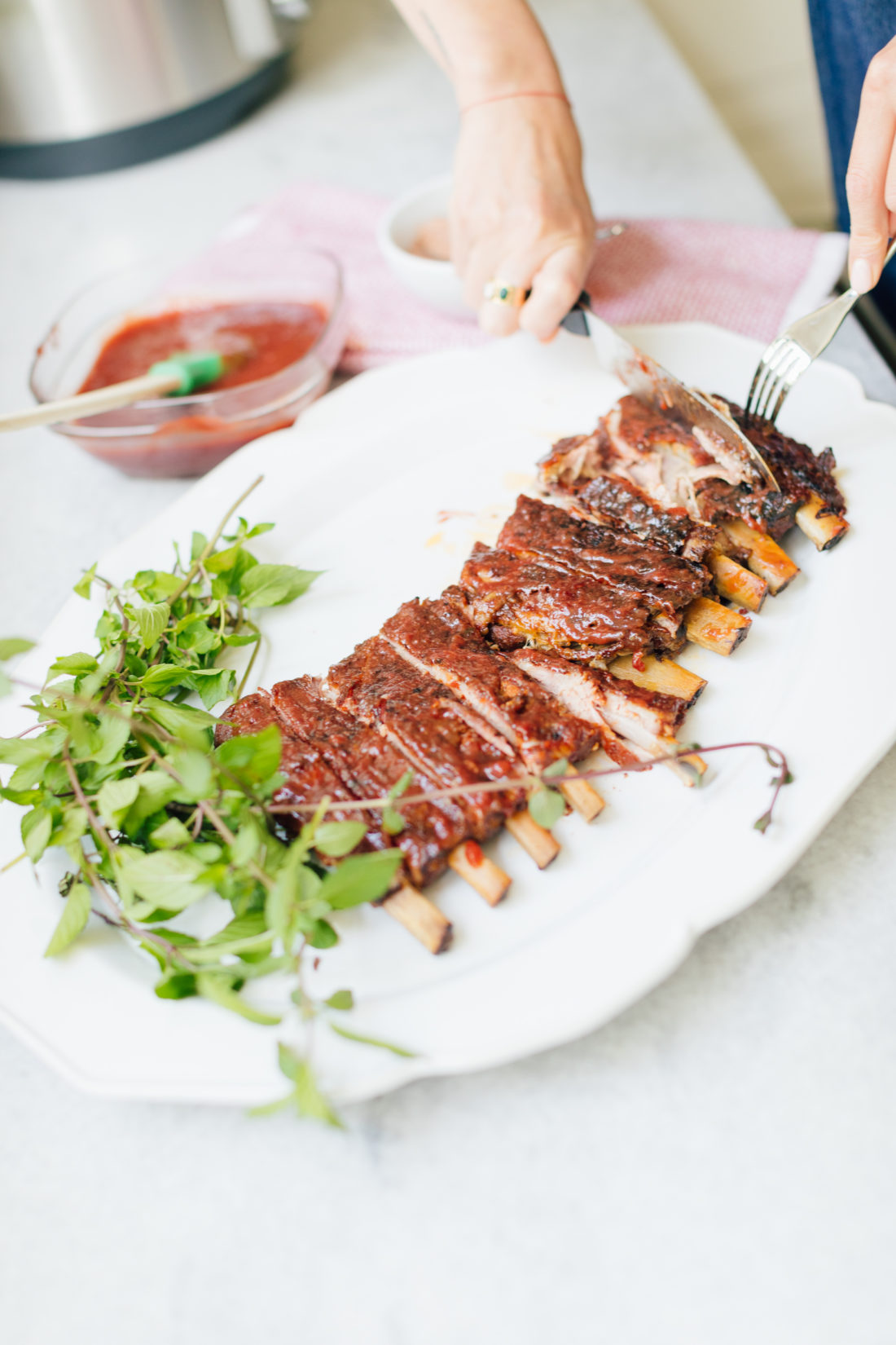Eva Amurri Martino cuts her rack of ribs on a serving dish