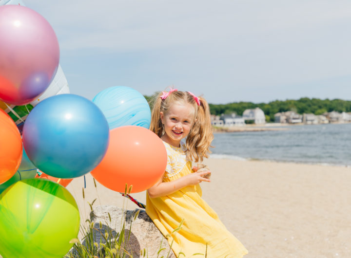 Marlowe Martino holds balloons on the beach in Connecticut to commemorate her 5th birthday