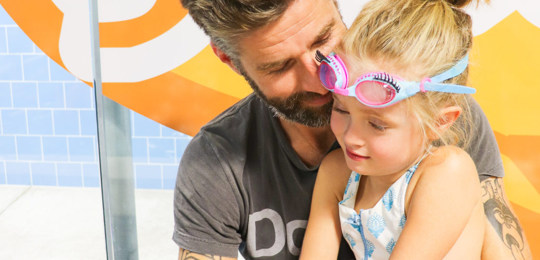 Kyle Martino holds daughter Marlowe before she has swim lessons at Goldfish Swim School