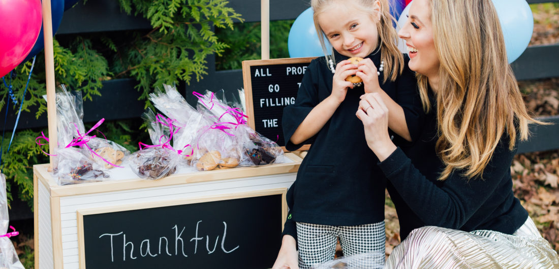 Eva Amurri Martino hugs daughter Marlowe at their bake sale benefitting nonprofit organization Filling in the Blanks